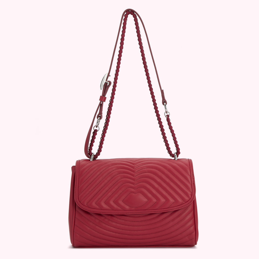 Red quilted shoulder bag with silver chain strap.
