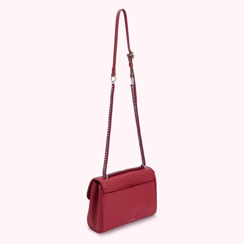 Red quilted crossbody bag with silver chain strap.
