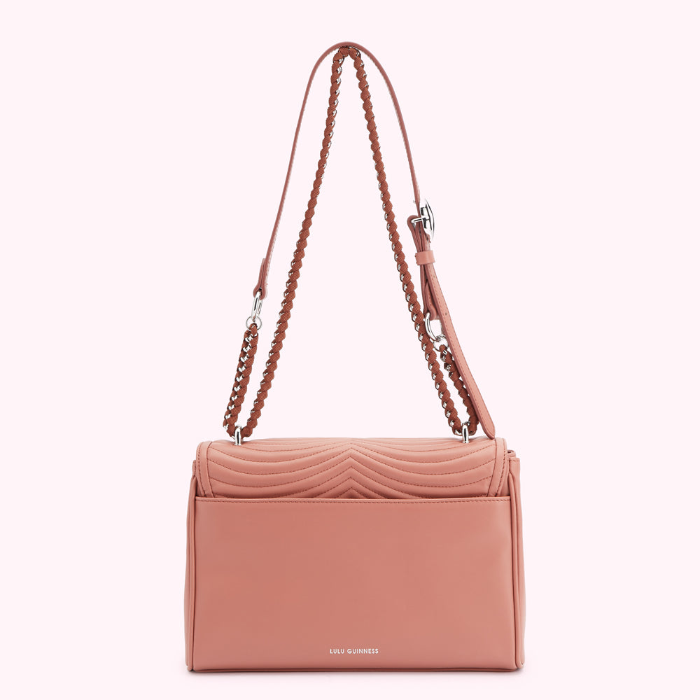 Dusty rose quilted shoulder bag with chain and leather strap detail. Lulu Guinness logo is visible on the back.
