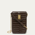 A dark brown croc effect embossed leather crossbody phone bag with a gold-tone clasp and chain strap, shown on a light off-white background.