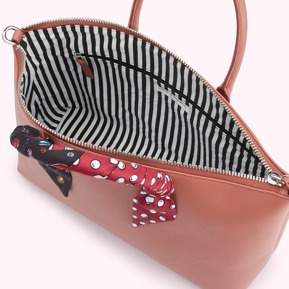 Dusty rose Lulu Guinness handbag with black and white striped interior and a patterned silk scarf accent.
