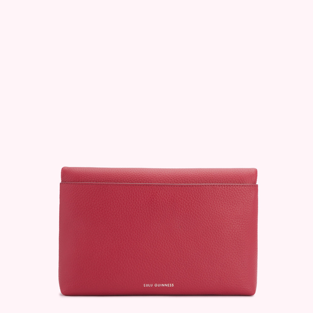 Red Lulu Guinness leather wallet on white background.
