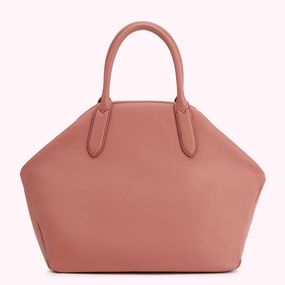 Dusty rose leather handbag with top handles.
