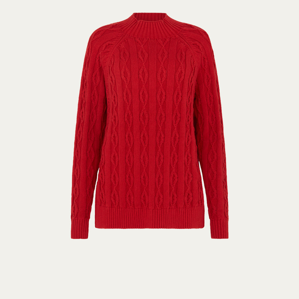 Red cable knit sweater on a light beige background