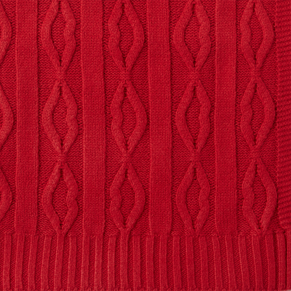 Close-up image of a red lip cable knit throw