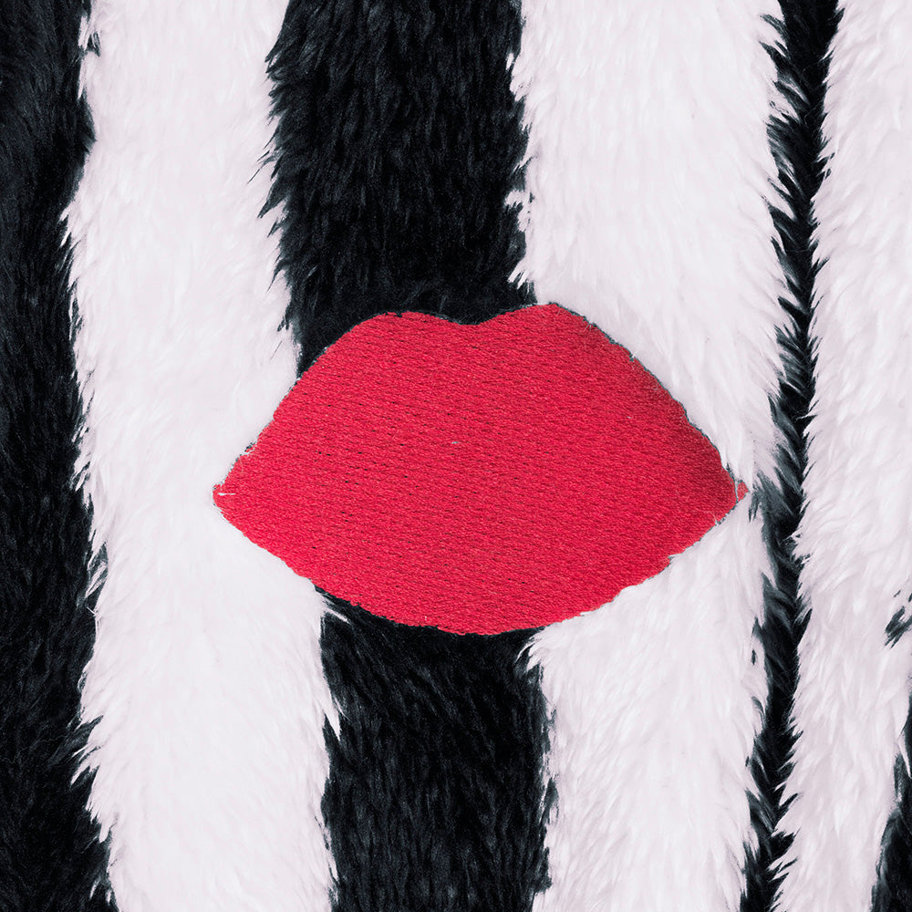 Close-up of black and white striped robe with a red embroidered lip