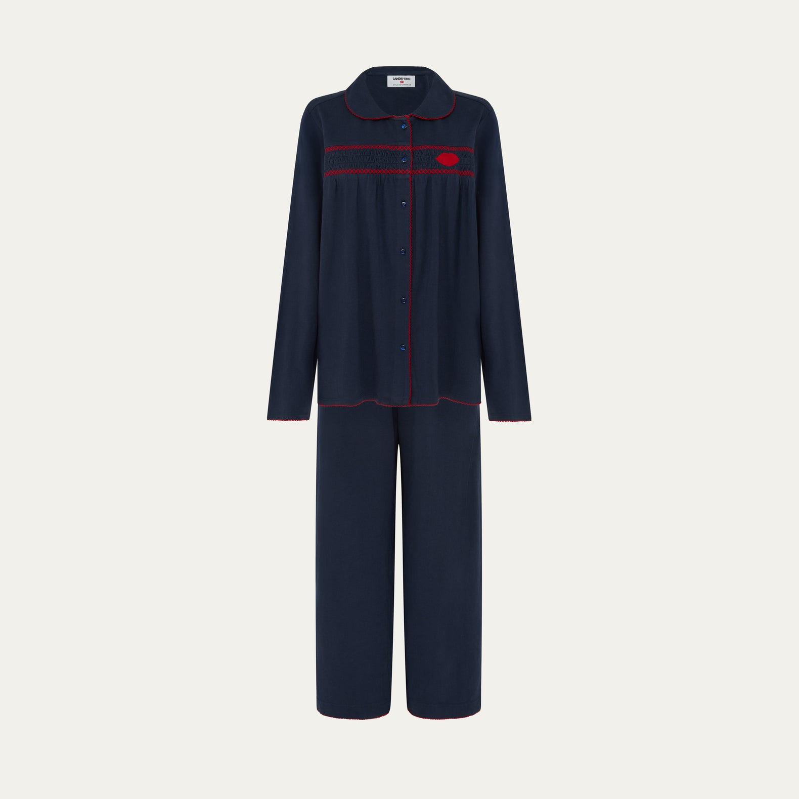 Navy pajama set with red accents on a light gray background