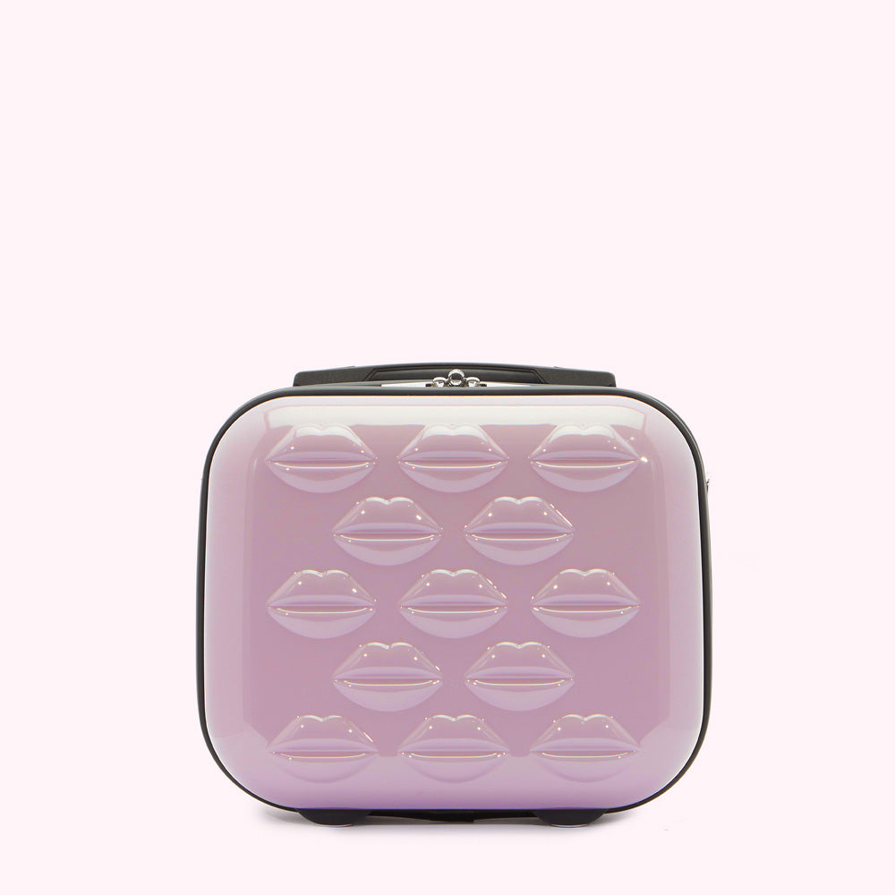 Lavender pink carry-on suitcase with lip-shaped embellishments.
