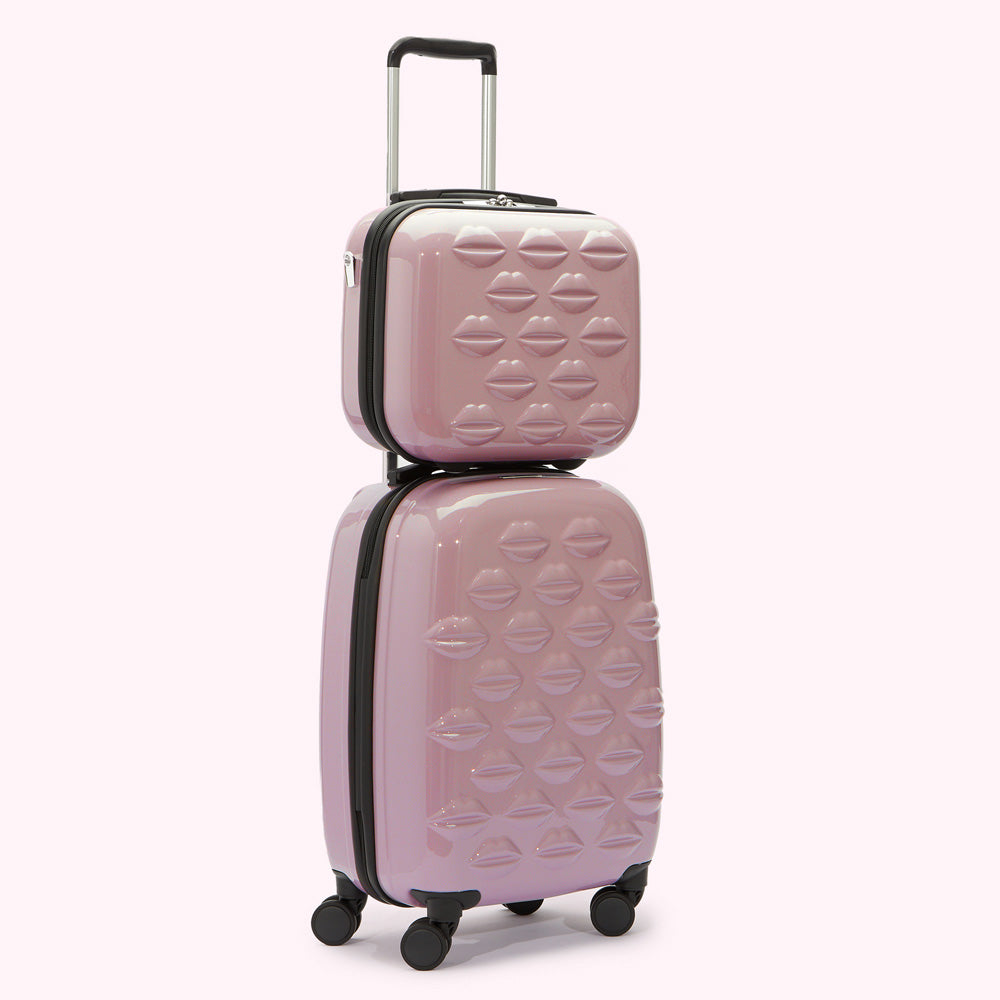 Pink suitcase set with lip print.
