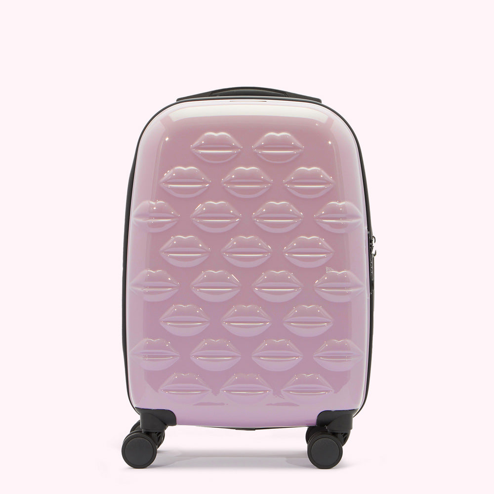Lavender pink carry-on suitcase with a pattern of embossed lips.
