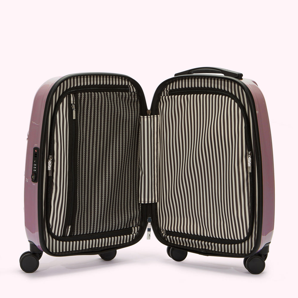 A mauve carry-on suitcase opened to reveal a black and white striped interior lining and small mesh pocket.
