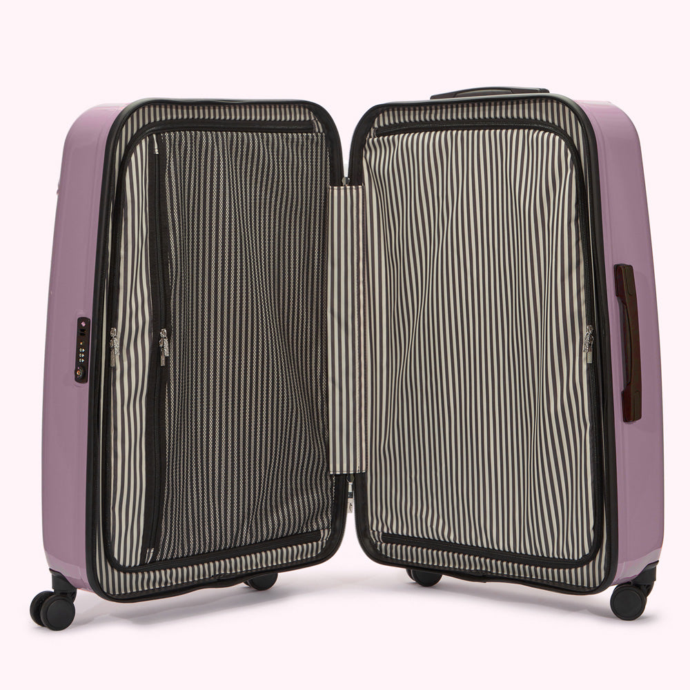 Open lavender suitcase with black and white striped interior lining.