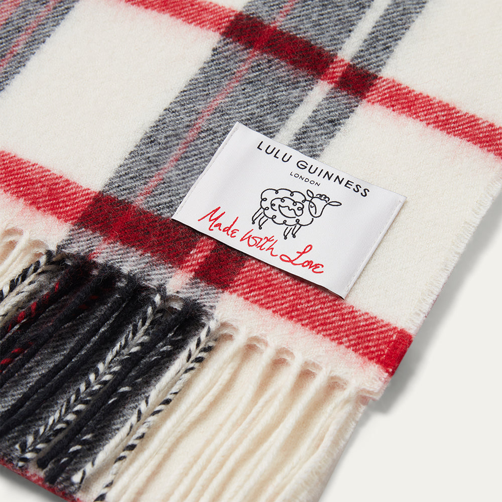 Plaid scarf with Lulu Guinness label on a white background