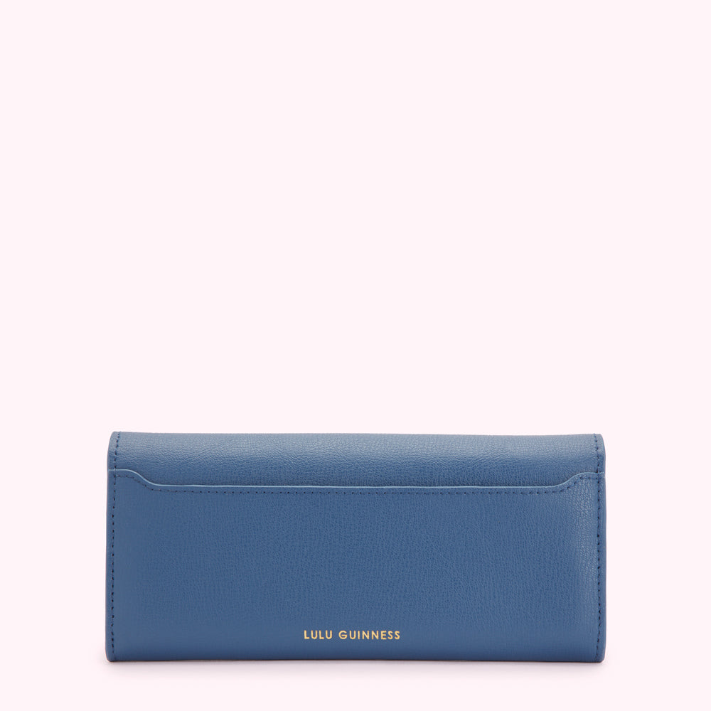 Rear view of a blue Lulu Guinness wallet against a white background.
