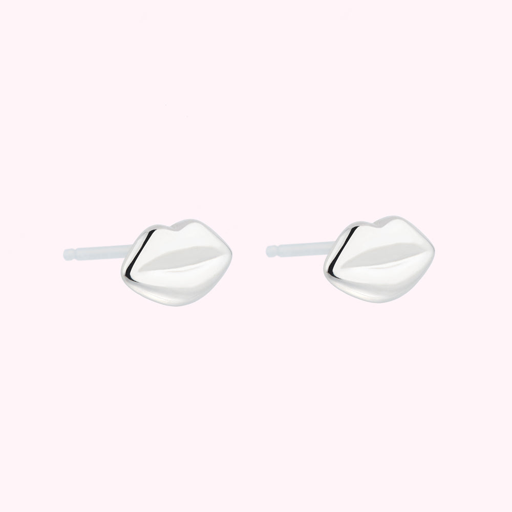 Pair of silver lip-shaped stud earrings.
