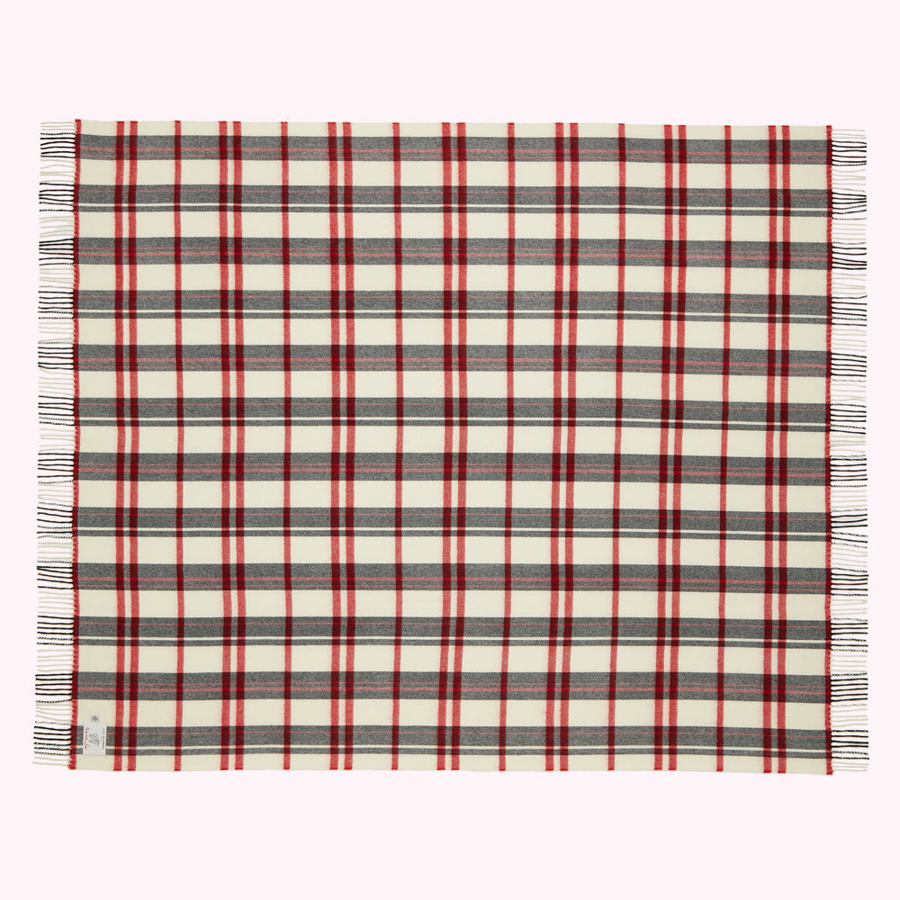 Cream-colored throw blanket with red and grey plaid or tartan pattern and fringe.
