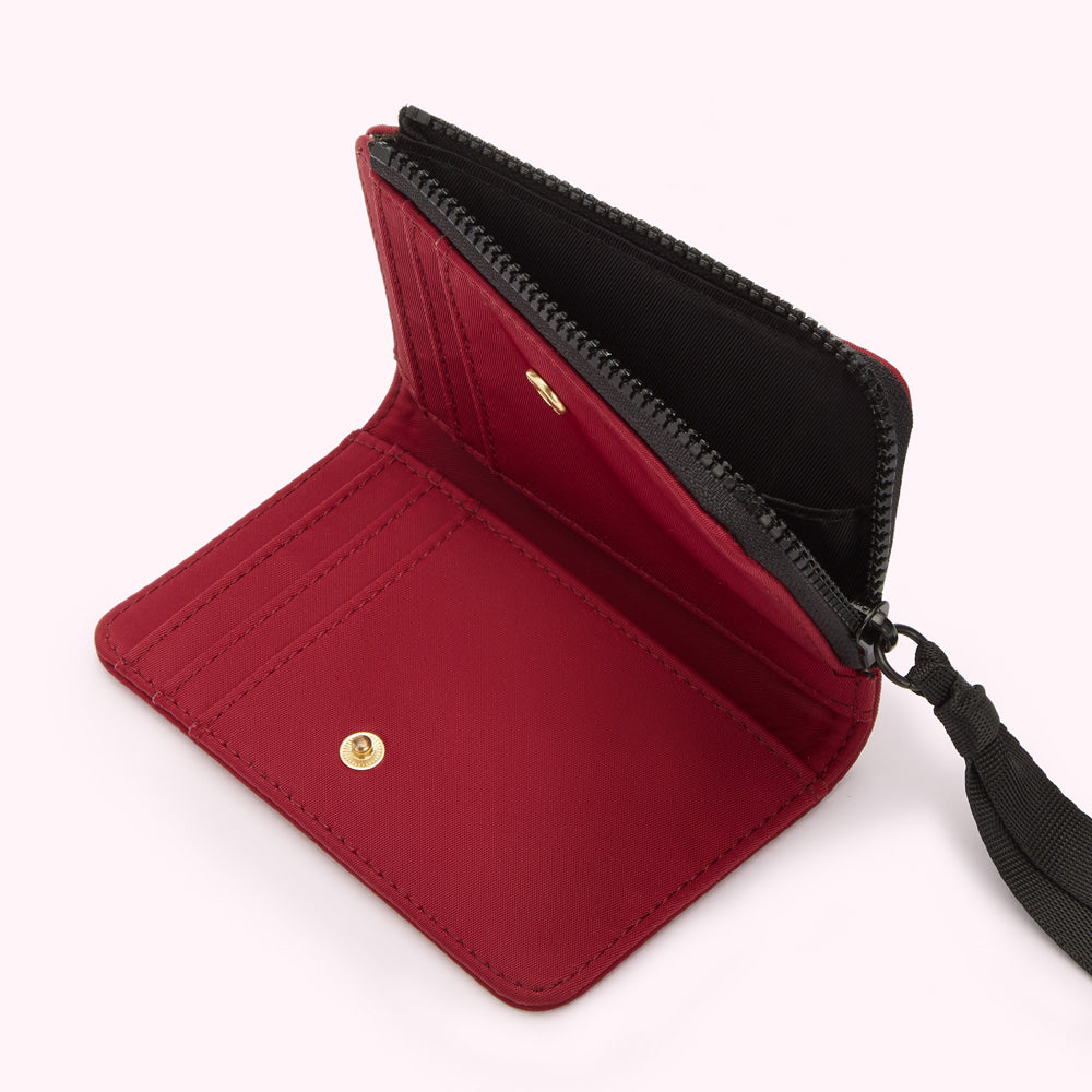 Red zipper wallet open to show interior compartments and black zipper.