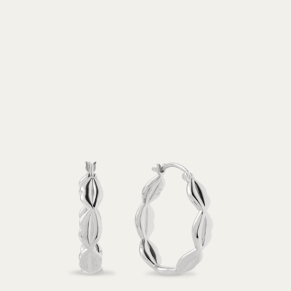 Silver hoop earrings on a light gray background