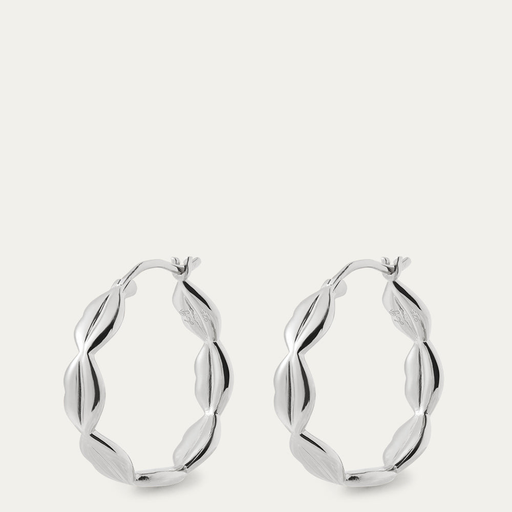 Silver hoop earrings on a light gray background
