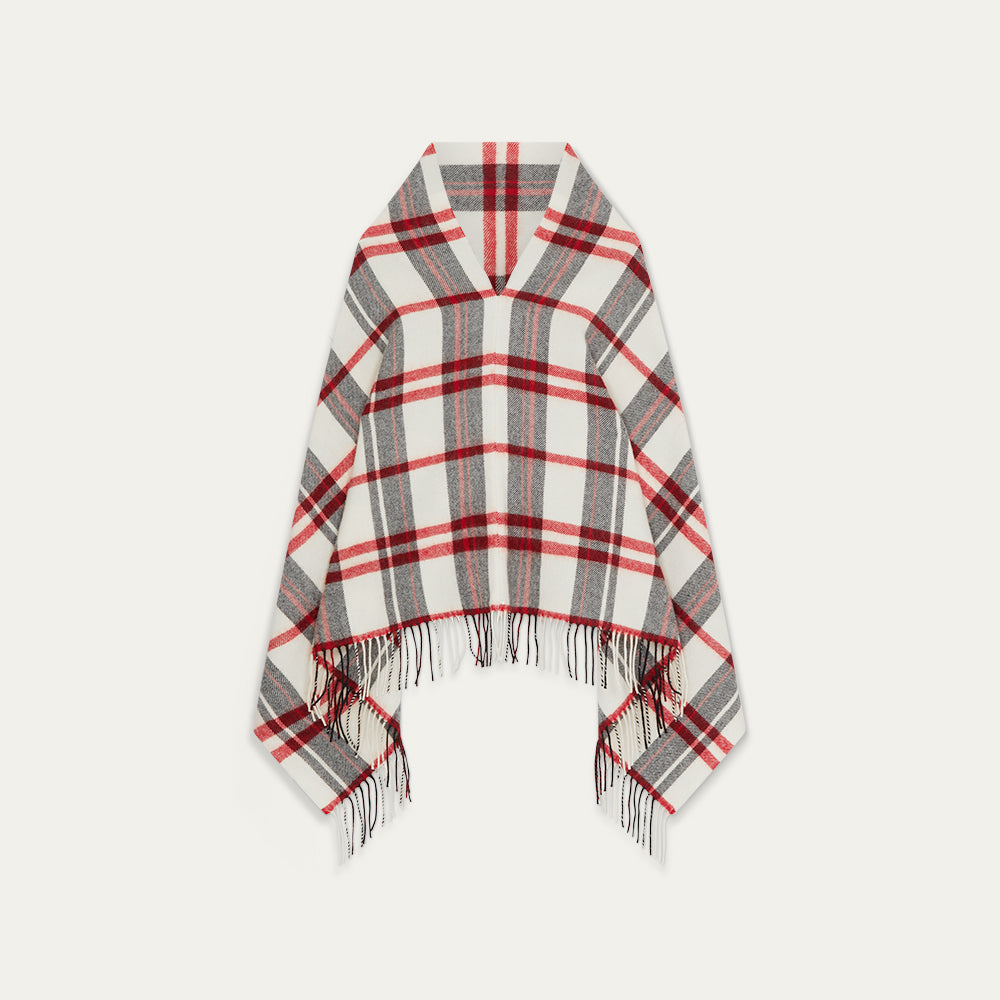 Plaid poncho with fringes on a white background