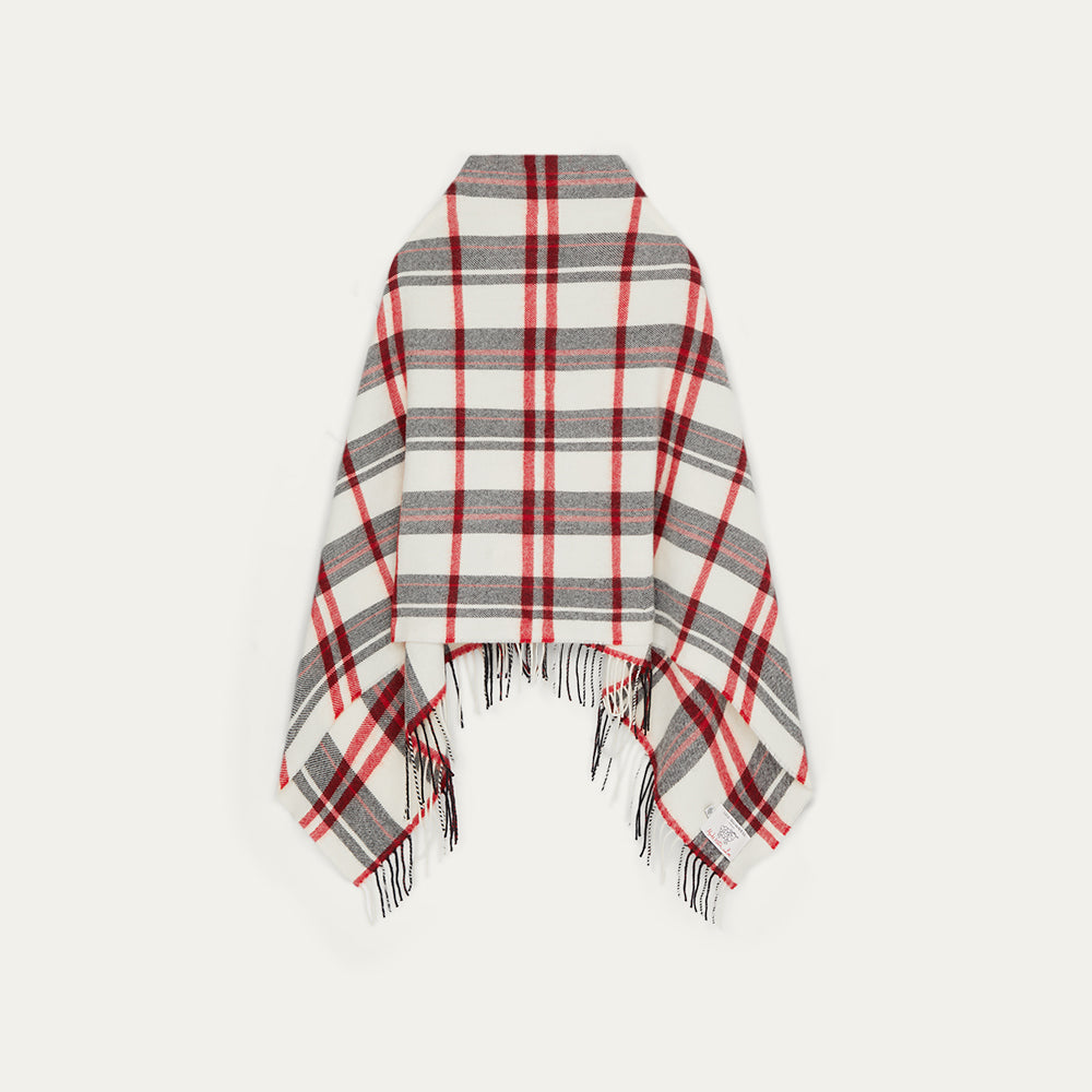 Plaid poncho with red, gray, and white pattern on a light gray background