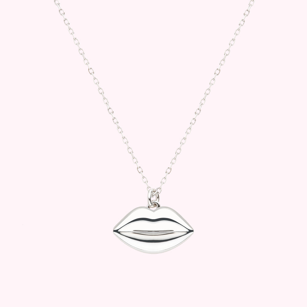 Silver necklace with a lip-shaped pendant.
