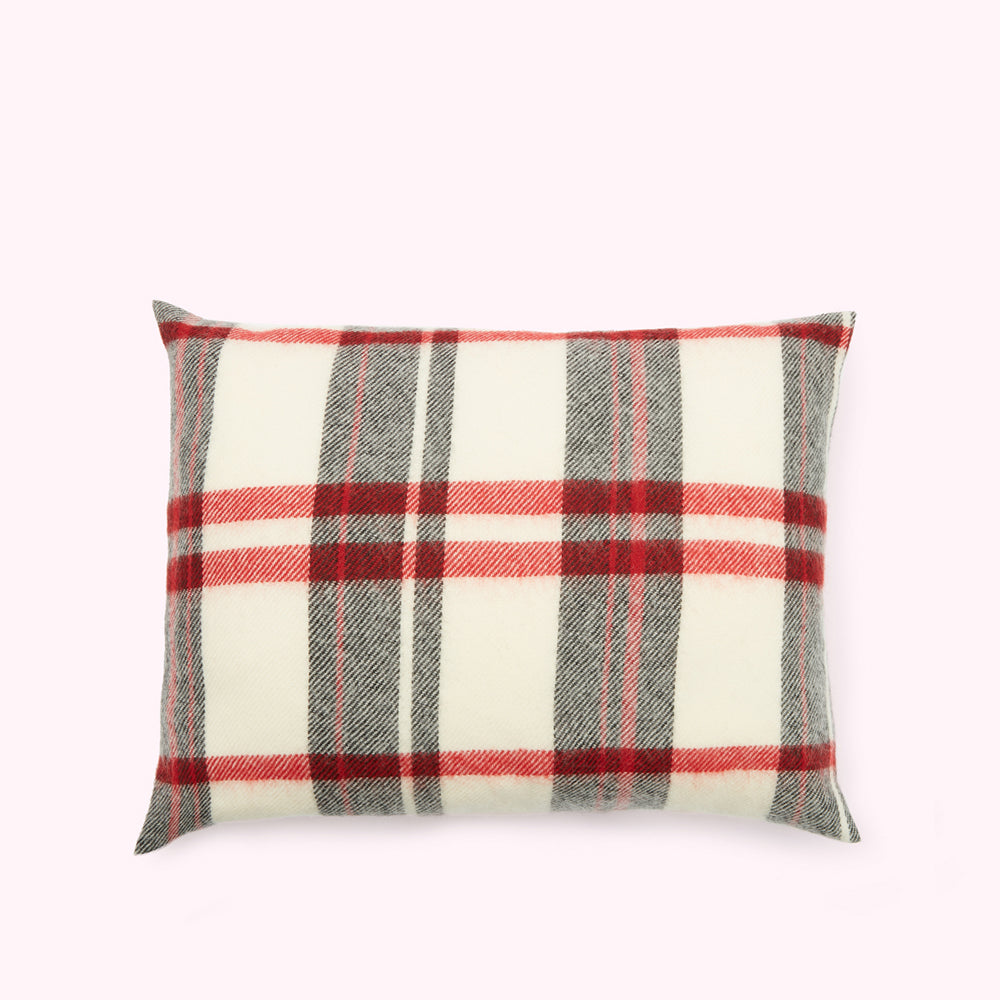 Rectangular pillow with a red and grey plaid or tartan pattern on a cream background.
