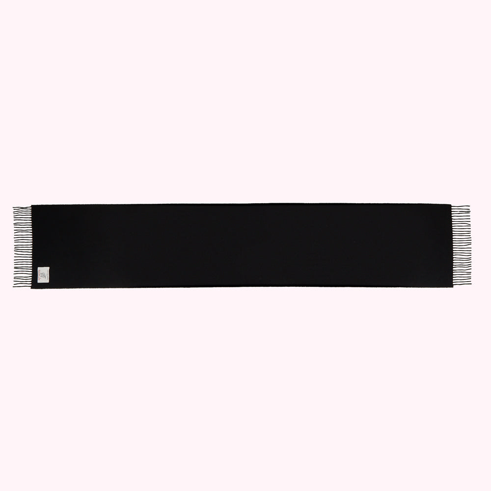 Black rectangular scarf with fringed edges and a small label.

