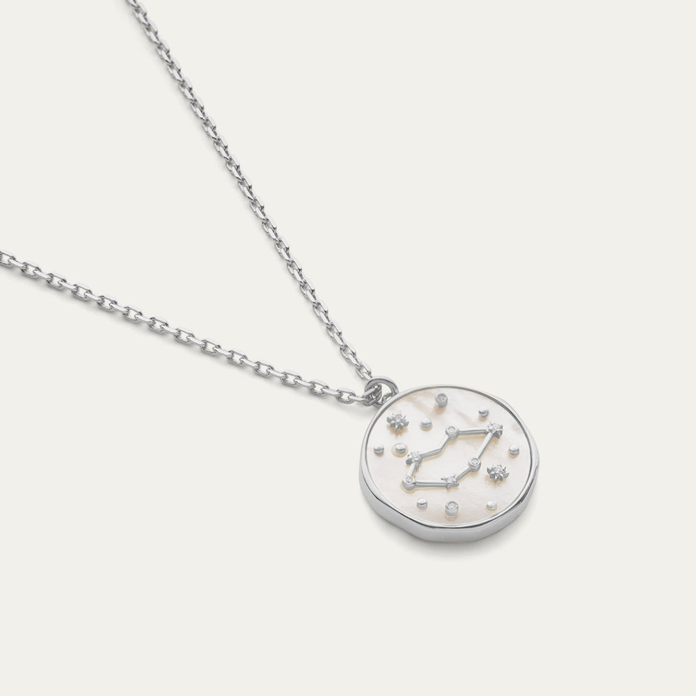 Silver necklace with a constellation and star pendant on a white background