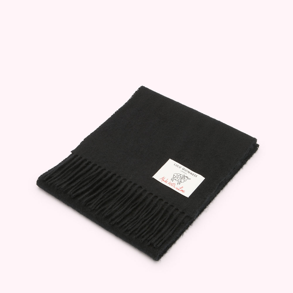Black Lulu Guinness wool scarf with a small white label that says "Made with Love".