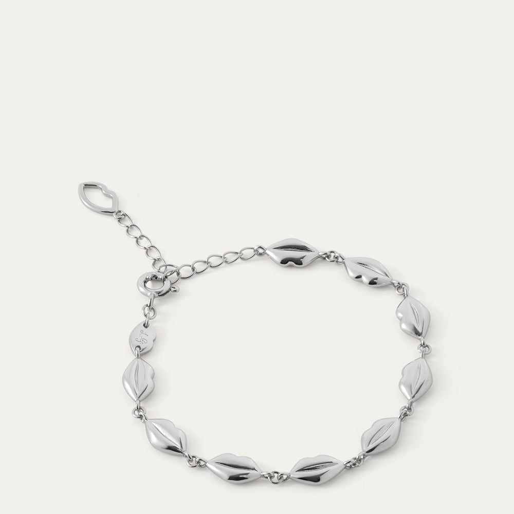 Silver bracelet with lip-shaped links on a white background