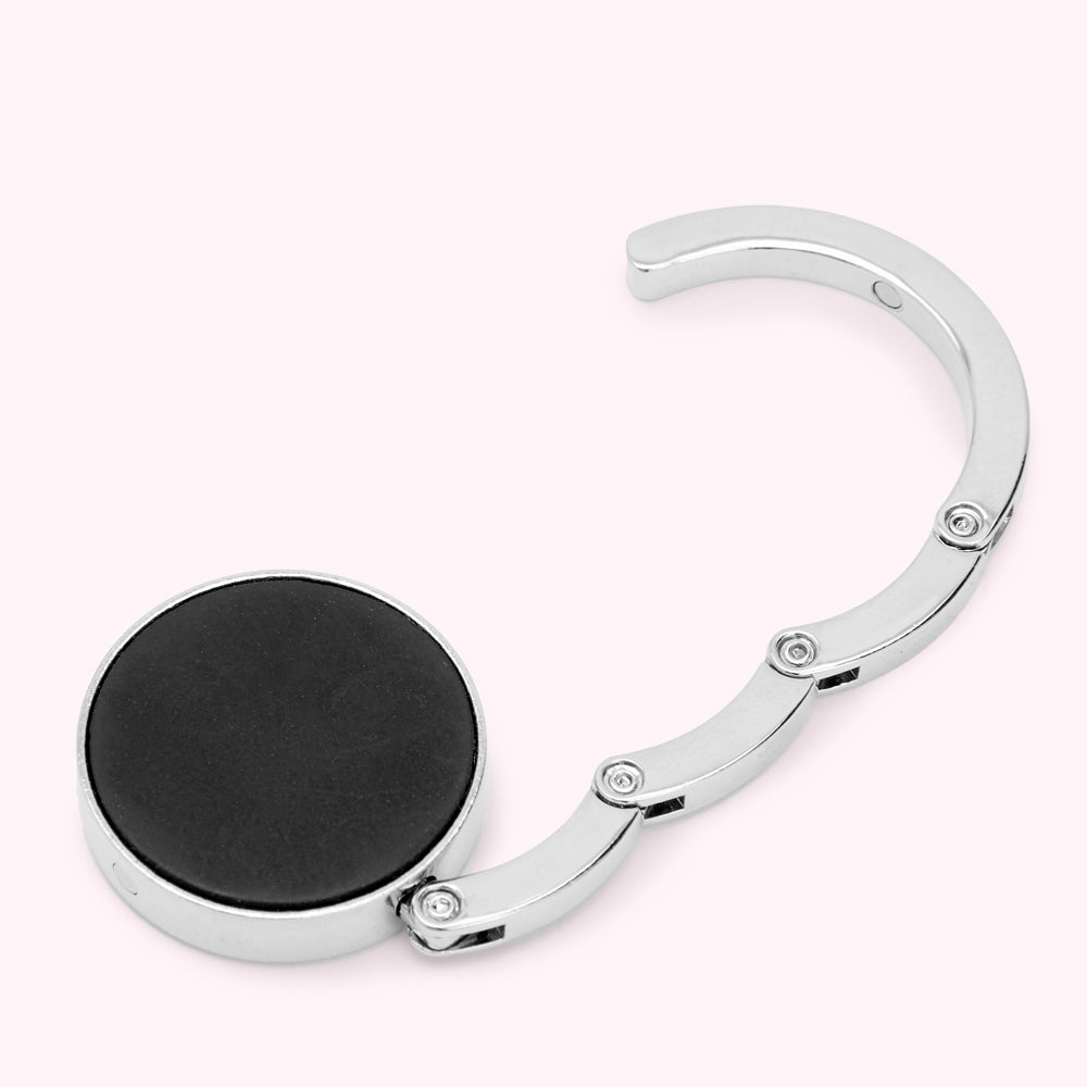 Silver and black handbag hook.