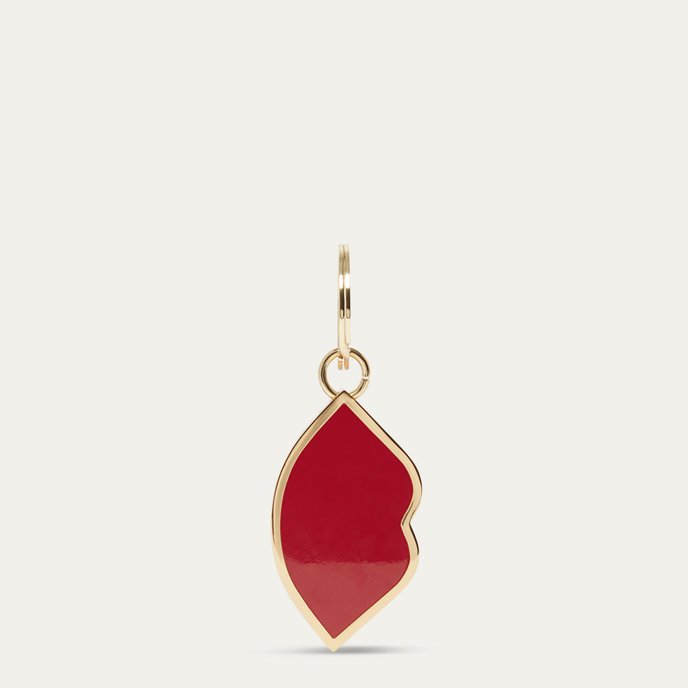 Gold and red lip-shaped keyring on a light gray background