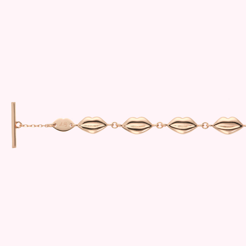 Rose gold lip-shaped charm bracelet.