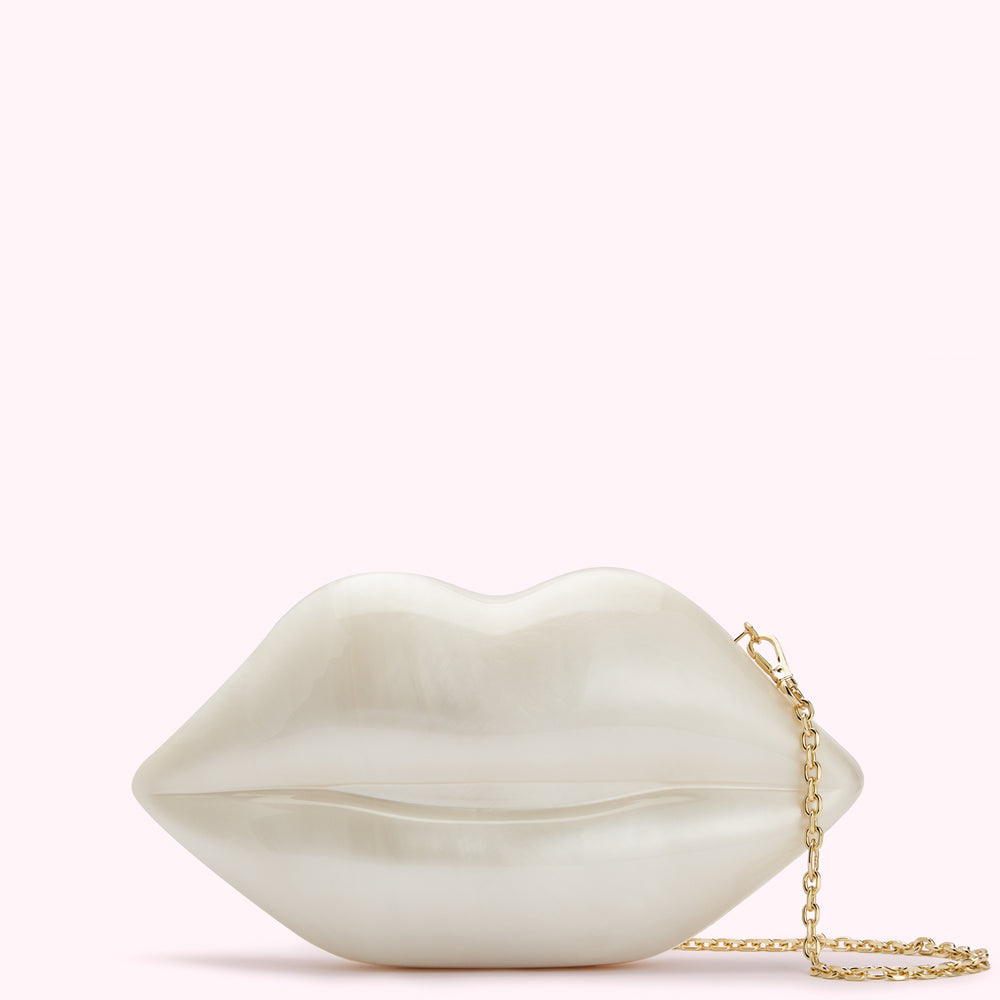 Off-white lips-shaped clutch with gold chain strap against a white background.

