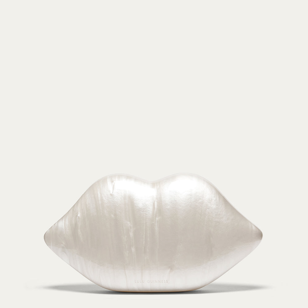 White pearl lip shaped clutch on a light gray background