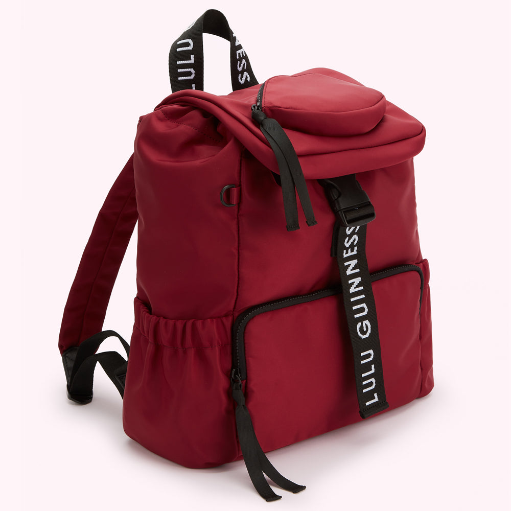 Burgundy Lulu Guinness backpack with black straps and zipper detailing.