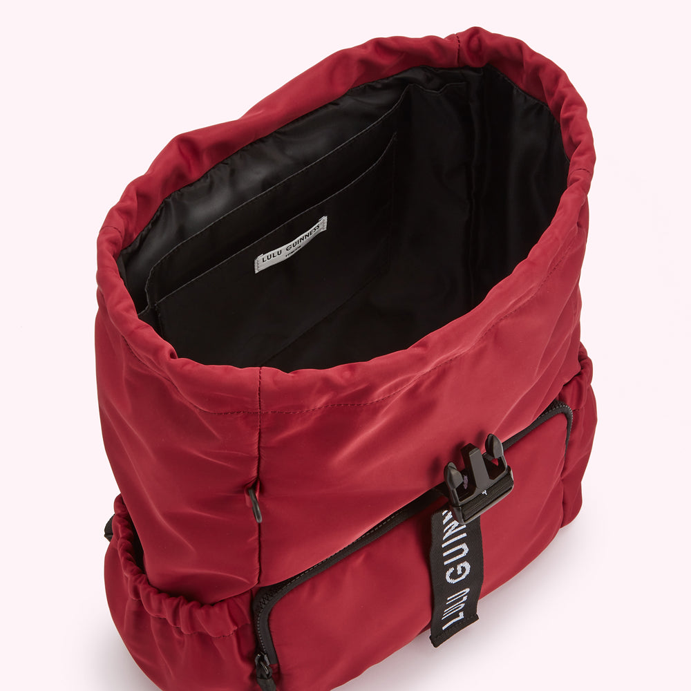 Inside of a red Lulu Guinness backpack.