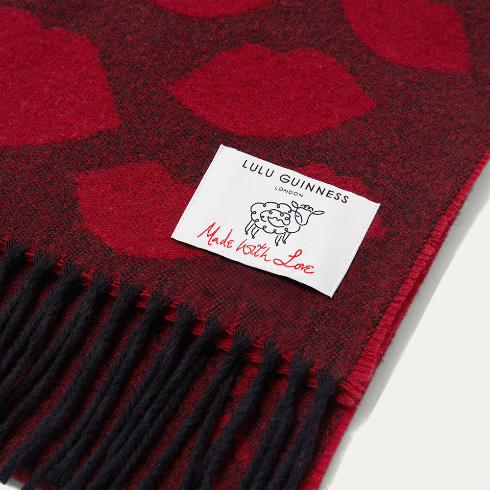 Red and black patterned scarf with Lulu Guinness label on a white background