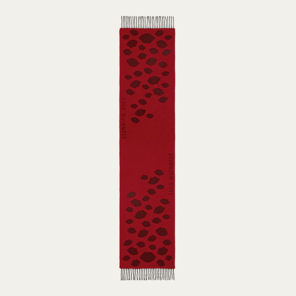 Red scarf with black lip pattern on a white background