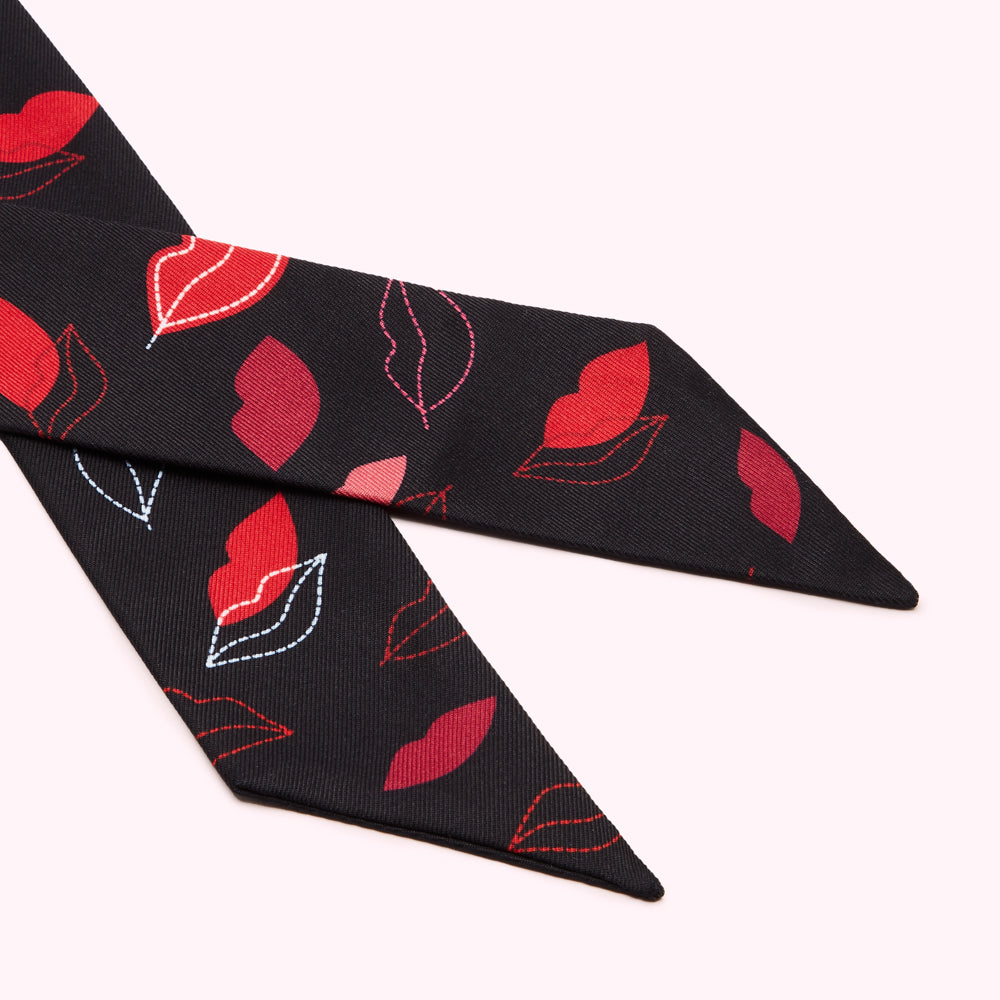 Black silk scarf with red lips pattern.