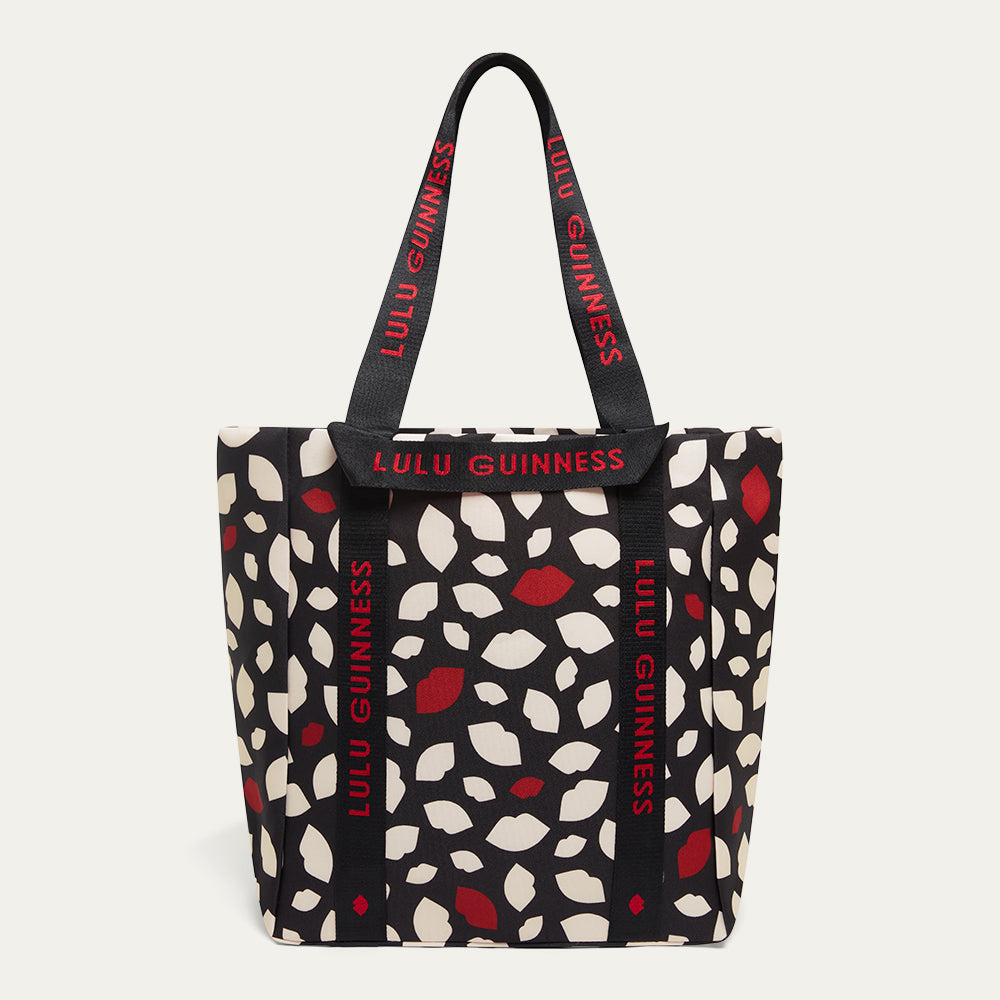 Tote bag with red and white lip flurry print and 'Lulu Guinness' branding on a white background