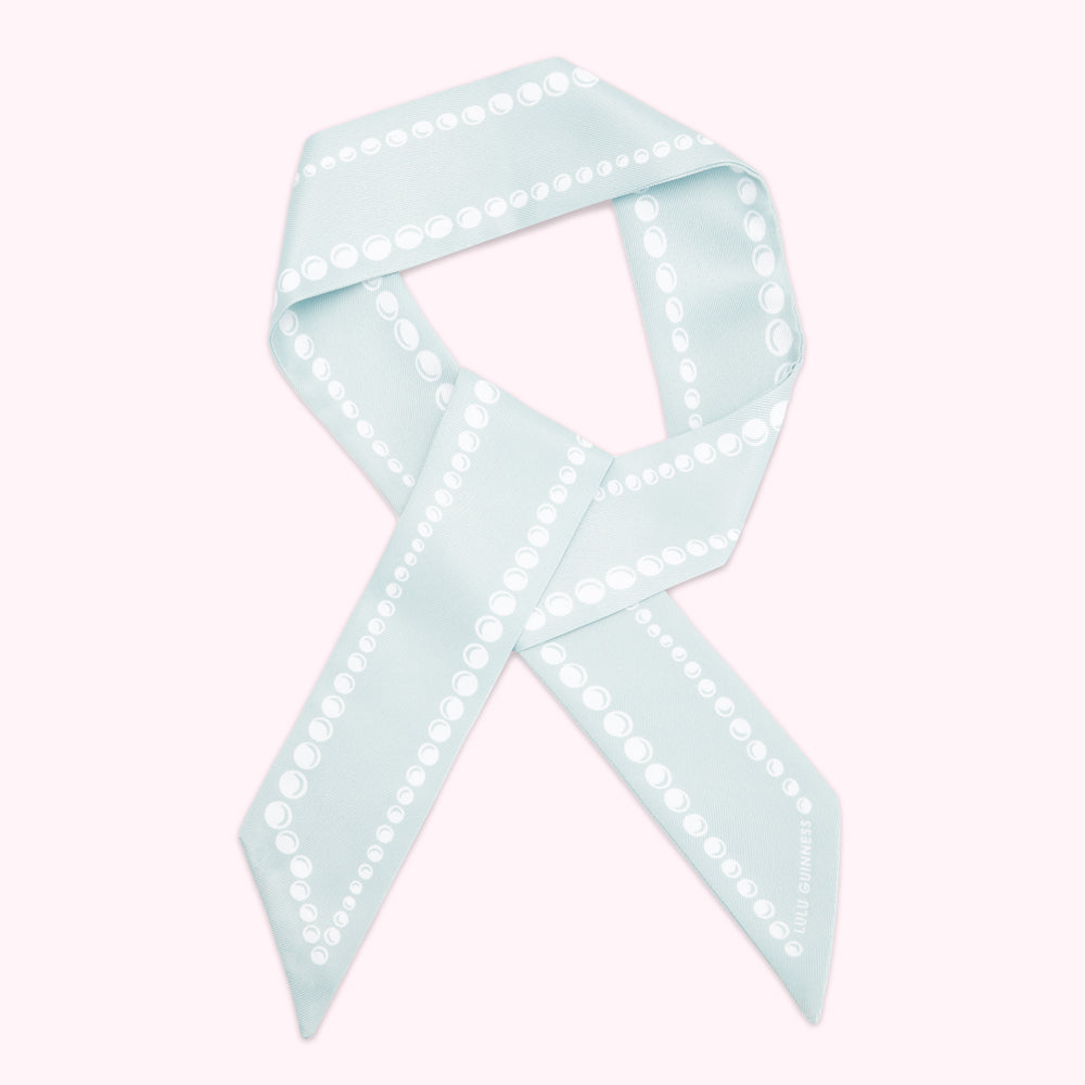 Light blue silk scarf with a pearl pattern. The Lulu Guinness logo is visible on the bottom right.
