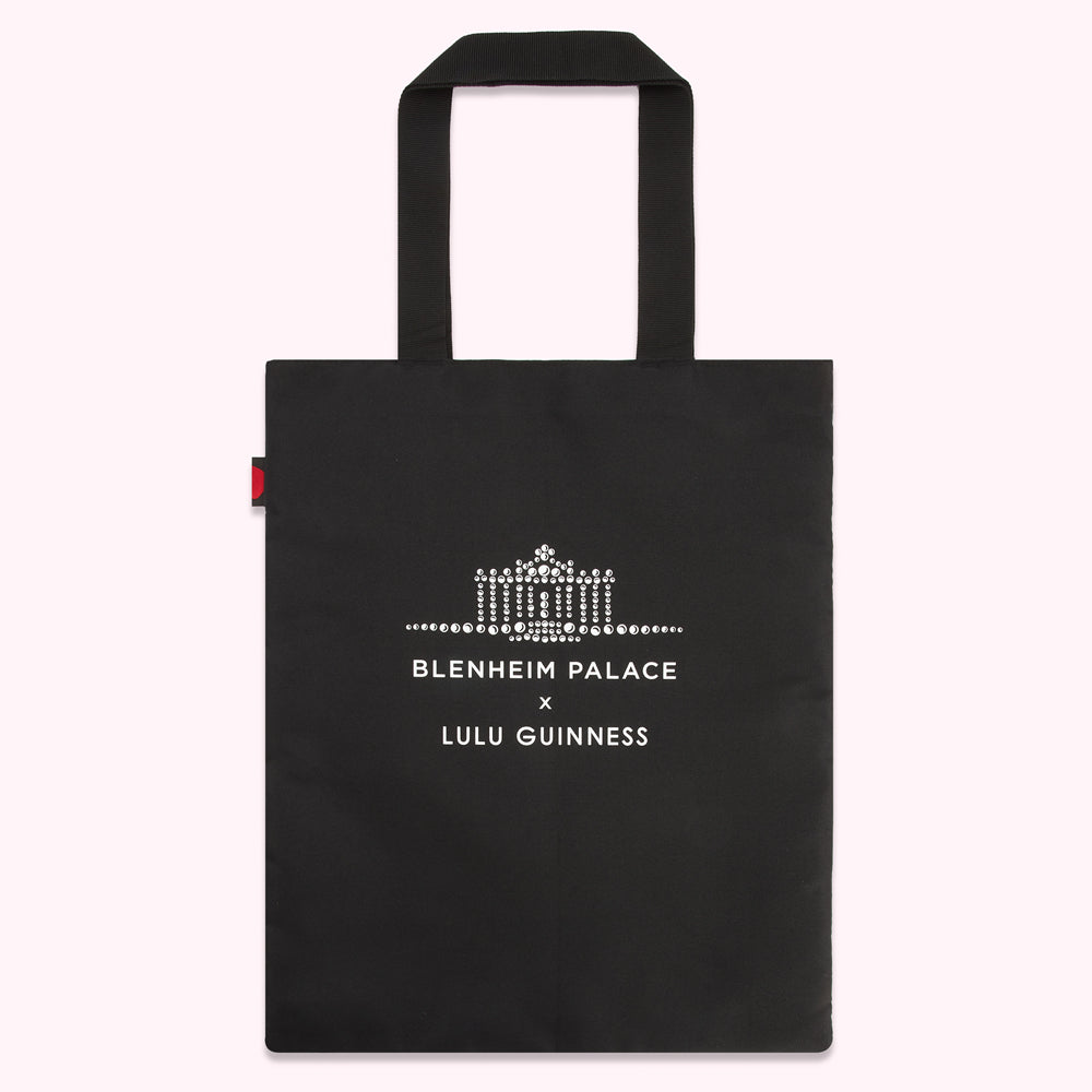 Black tote bag with a rhinestone Blenheim Palace logo and Lulu Guinness branding.
