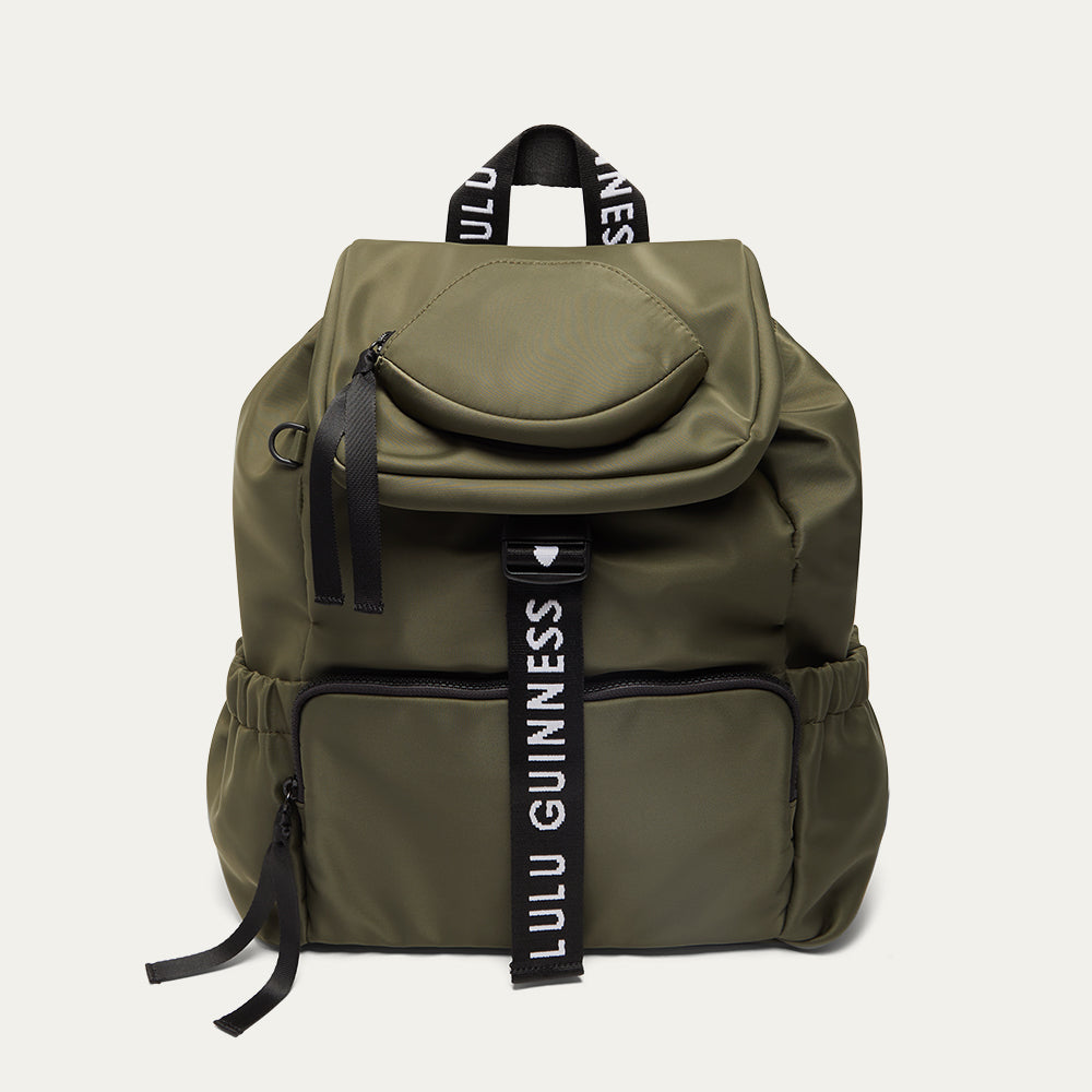 Green backpack with 'Lulu Guinness' branding on a white background