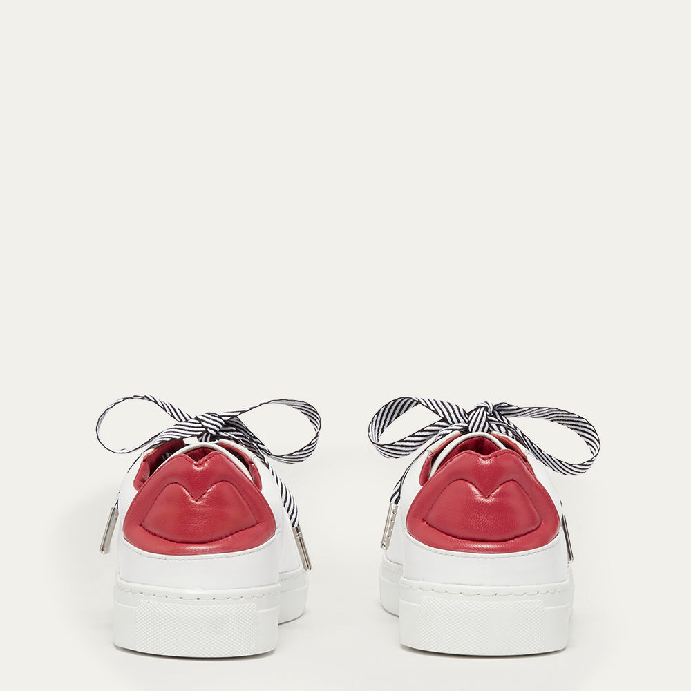 Back image of white trainers with red lip details on the backs on a white background