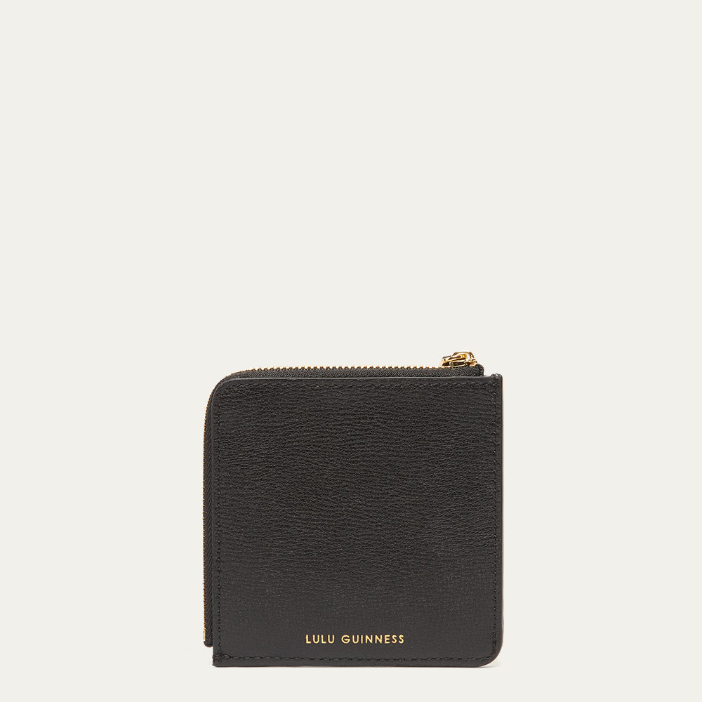 Black wallet with gold zipper and 'Lulu Guinness' branding on a white background