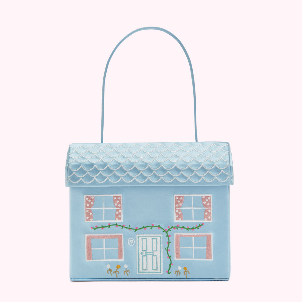 Light blue house-shaped handbag with embroidered details.
