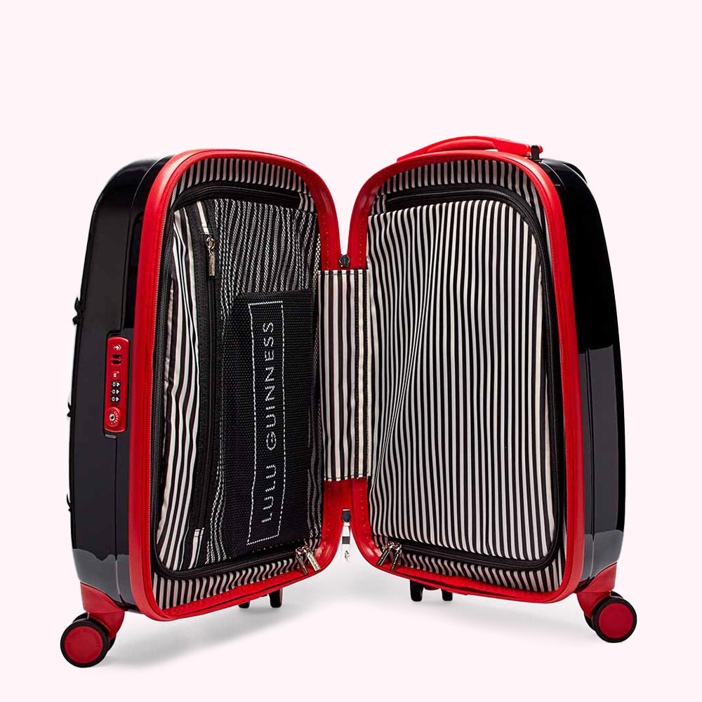 Open black and red Lulu Guinness suitcase with black and white striped interior.
