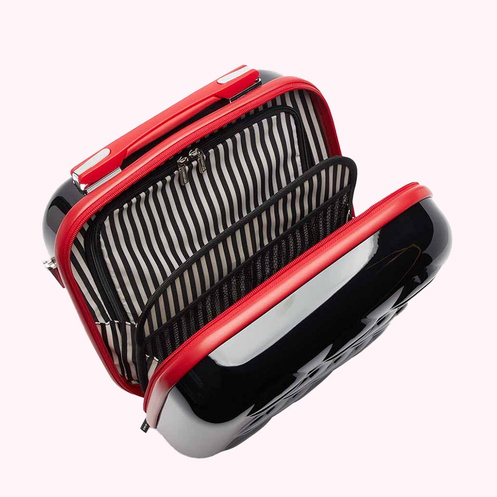 Open black and red hard-shell cosmetic case with black and white striped interior.